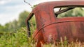 Old rusting vintage car or barn find in an overgrown field Royalty Free Stock Photo