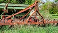 Old, rusty and abandoned agricultural machinery among the undergrowth on a fruit farm Royalty Free Stock Photo
