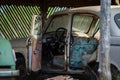 an old rusty abandoned car with its doors open Royalty Free Stock Photo