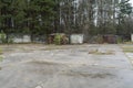 old and rusty abandoned containers into a parking with autum forest background at chernobyl