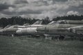 Old rusty abandoned planes stand on the grass under the open sky. Vintage military aircraft. Royalty Free Stock Photo