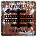 Old rusty American road sign - Divided highway transit rail crossing Royalty Free Stock Photo