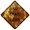 Old rusty American road sign - No train horn warning Royalty Free Stock Photo