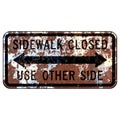 Old rusty American road sign - Sidewalk Closed Use Other Side