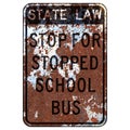 Old rusty American road sign - State law stop for stopped school bus, New York