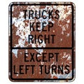 Old rusty American road sign - Trucks keep right except left turns