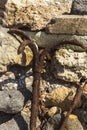 Old rusty anchor on a background of stones Royalty Free Stock Photo