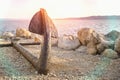 Old rusty anchor on the beach with stones Royalty Free Stock Photo