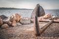 Old rusty anchor on the beach with stones Royalty Free Stock Photo