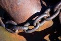 Old rusty anchor chain around the metal bollards Royalty Free Stock Photo