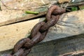 An old rusty anchor chain. Fixing the boat on the pier. Rusty iron construction Royalty Free Stock Photo