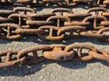 An old rusty anchor chain is laid out on the berth for disposal Royalty Free Stock Photo