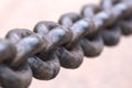 Old rusty anchor chain in the port. Iron chain links defocused diagonally. Blurred background Royalty Free Stock Photo