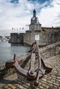 Old rusty anchor at the entrance of the closed city of Concarneau in FinistÃÂ¨re, Brittany France