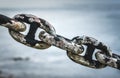 Old rusty anchor iron ship chain in sea port. Royalty Free Stock Photo