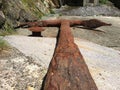 Old rusty anchor lying on the shore Royalty Free Stock Photo