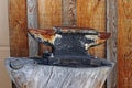 An old rusty anvil on a tree stump Royalty Free Stock Photo