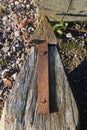 Old rusty arrow attached to a wooden post