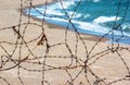 Old rusty barbed wire fence on a beach Royalty Free Stock Photo