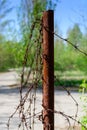 Old and rusty barbed wire on a metal pole. Ghost Town Pripyat. Royalty Free Stock Photo