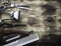 Old rusty barber shop tools on wood background