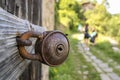 Old rusty barn lock. Closed lock on the metal handle of a wooden door. Close-up lock on door. Royalty Free Stock Photo