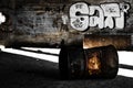 Rusty barrel and graffitis in industrial ruins