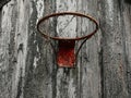 Old rusty basketball hoop mounted on a wooden wall of a barn of a farm. Popular sport. Practice and develop skill in tough rough Royalty Free Stock Photo