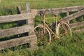 Old rusty bicycle against a fence in Holland