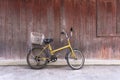 Old rusty bicycle leaning against wooden wall Royalty Free Stock Photo