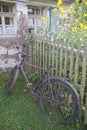 Old rusty bicycle leaning against wooden fence Royalty Free Stock Photo