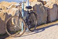 Old rusty bicycle parked against a rock wall Royalty Free Stock Photo