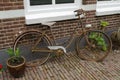 Old rusty bike against a property in the Netherlands