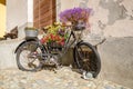 Old bike decorated with gorgeous flowers in S-Chanf Grisons, Switzerland