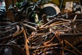 Old rusty bikes, bicycles, retro car details and other vintage items lying in a heap and waiting for their museum restoration. Royalty Free Stock Photo