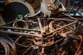 Old rusty bikes, bicycles, retro car details and other vintage items lying in a heap and waiting for their museum restoration.