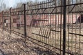 old rusty black iron fence. rust and mold are visible on the bars Royalty Free Stock Photo