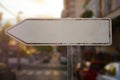 old rusty blank sign board with arrow to left stand in city while sundown is a mock up Royalty Free Stock Photo