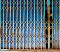 Old rusty blue folding metal door