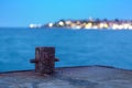 Old rusty bollard on the dock at night