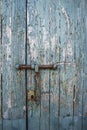 Old and rusty bolt and lock on exterior door with blue paint Royalty Free Stock Photo