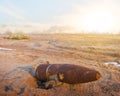 Old rusty bomb lie on a sand