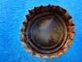 Old Rusty Bottle Cap Bottlecap on Blue Background Royalty Free Stock Photo