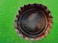 Old Rusty Bottle Cap Bottlecap on Green Background Royalty Free Stock Photo