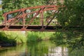 An Old, Rusty Bridge Over A River, Closed For Cars