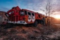 Old rusty broken abandoned Soviet fire truck on evening sunset Royalty Free Stock Photo