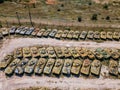 Old rusty broken Russian military vehicles in industrial area, aerial view