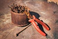 Old rusty broken tools, nails and pliers on a background of rust Royalty Free Stock Photo