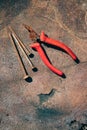 Old rusty broken tools, nails and pliers on a background of rust Royalty Free Stock Photo