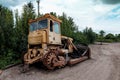 Rusty, broken yellow bulldozer